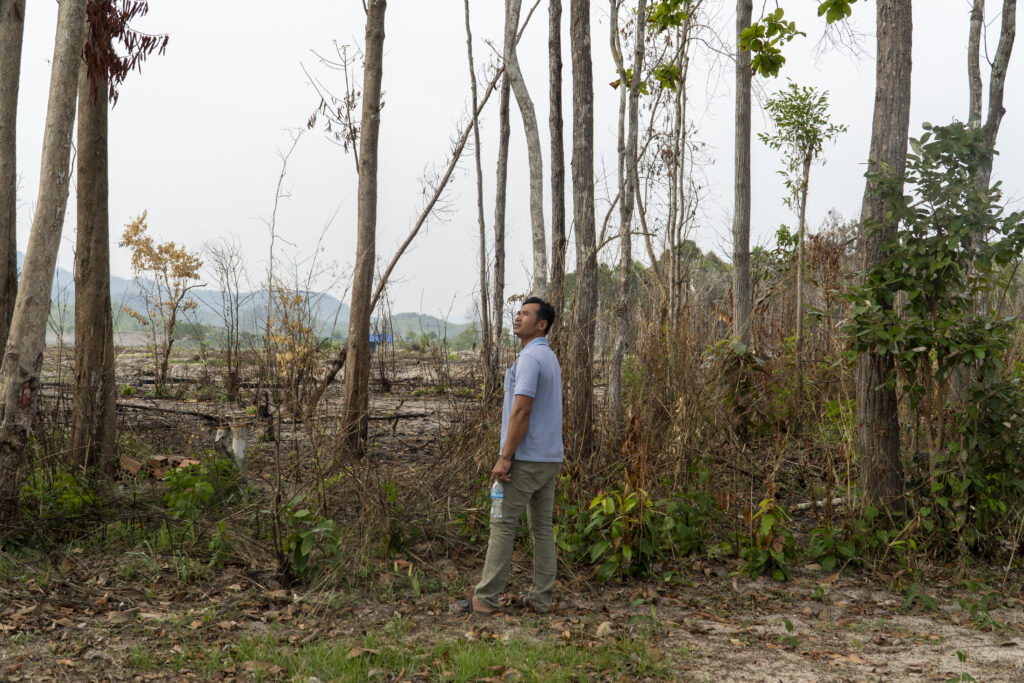 Khon Sarith, a Po Meas village resident and advocate for Metta Forest, stands among trees on the edge of soldiers' cleared territory, in Kampong Speu province's Trapaing Chor commune on April 8, 2025. (Meng Kroypunlok/MI)