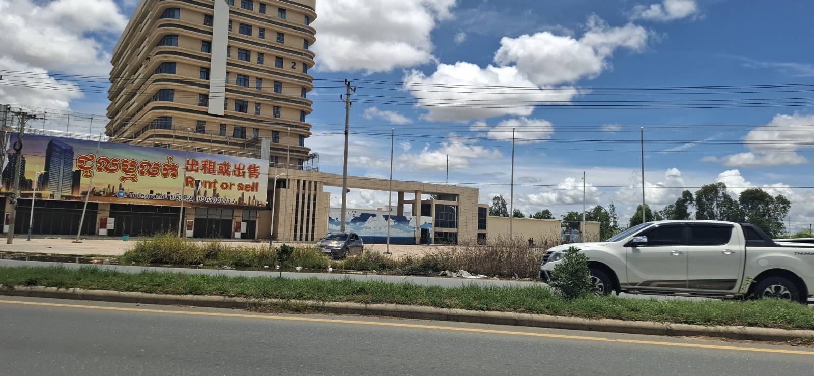 "Mango Park", the business compound that allegedly hosted scam businesses, had posted a sign offering to "rent or sell" the building on August 13, 2025 in Cambodia's Kampong Speu province. (Danielle Keeton-Olsen/Mekong Independent)