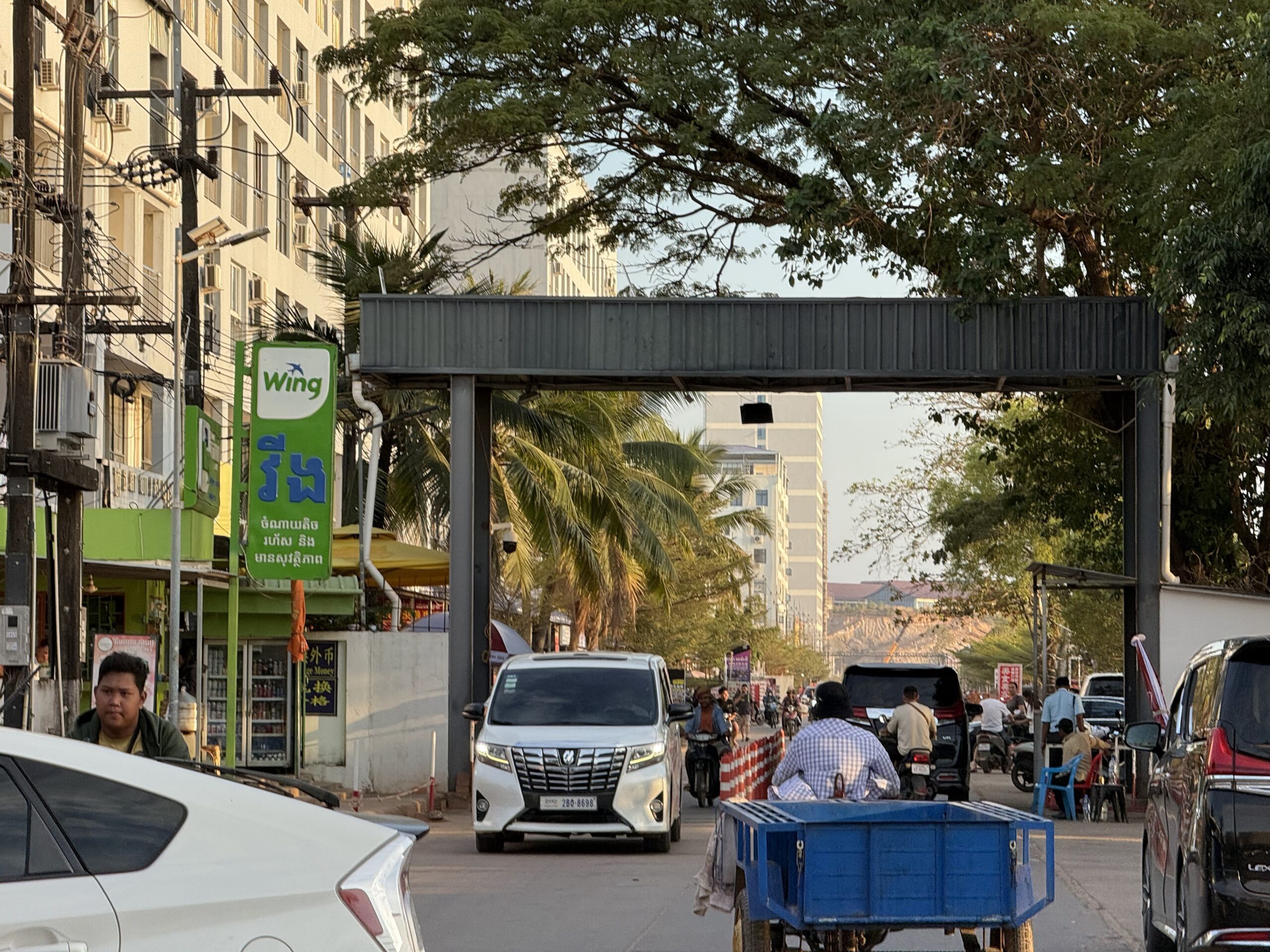 Vans, motorbikes and trailers drive in and out of a gate to the Koh Kong Resort during an opening-up of reported scam businesses in Cambodia's Koh Kong province on January 25, 2026. (Mech Dara/Mekong Independent/Creative Commons)