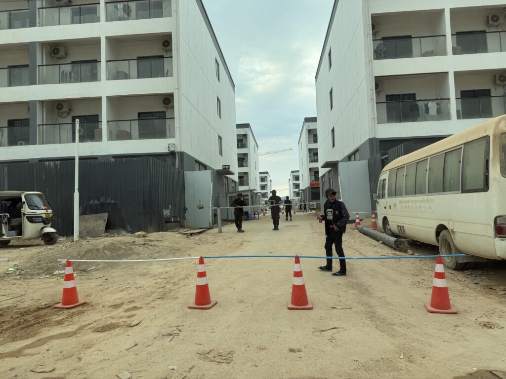 Workers install barricades blocking the roads between buildings in the under-construction Prek Khsach compound on February 12, 2026 in Cambodia's Koh Kong province. (Mech Dara/Mekong Independent)