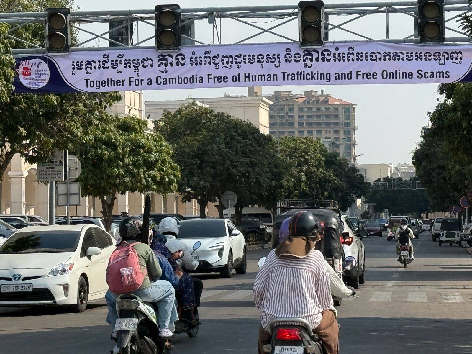 A banner promoting anti-human trafficking and anti-scam efforts hangs over the road in Phnom Penh's Koh Pich island on February 25, 2026. (Mech Dara/Mekong Independent/Creative Commons)