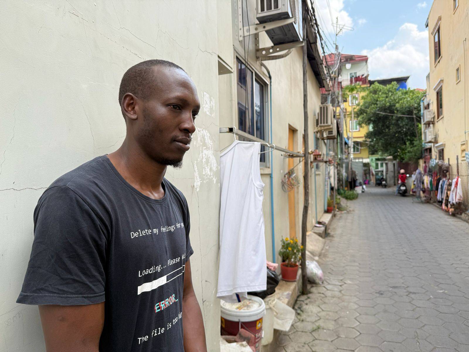Kamya Paul, who says he was trafficked from Uganda to Cambodia, stands in an alley in Phnom Penh on March 3, 2026. (Mech Dara/Mekong Independent/Creative Commons)
