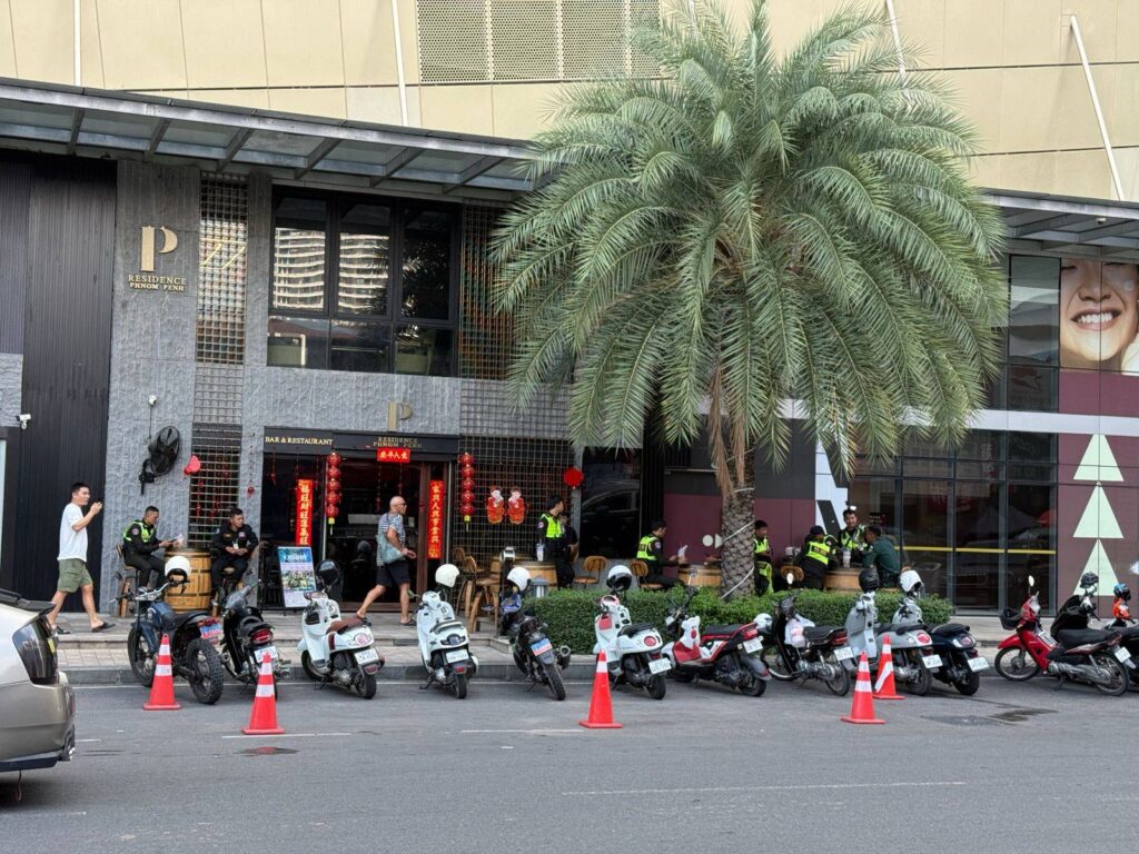 People walk in front of the entrance to The Peak in Phnom Penh. (Mech Dara/Mekong Independent/Creative Commons)